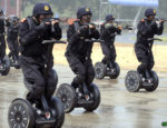 In this photo released by the official Xinhua news agency, members of China's armed police demonstrate a rapid deployment during an anti-terrorist drill held in Jinan, east China, on Wednesday July 2, 2008, roughly one month ahead of the Beijing Olympic Games. (AP Photo/Xinhua/Fan Changguo)
