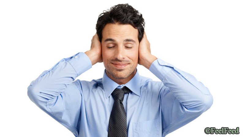 Young businessman looking placid while covering his ears