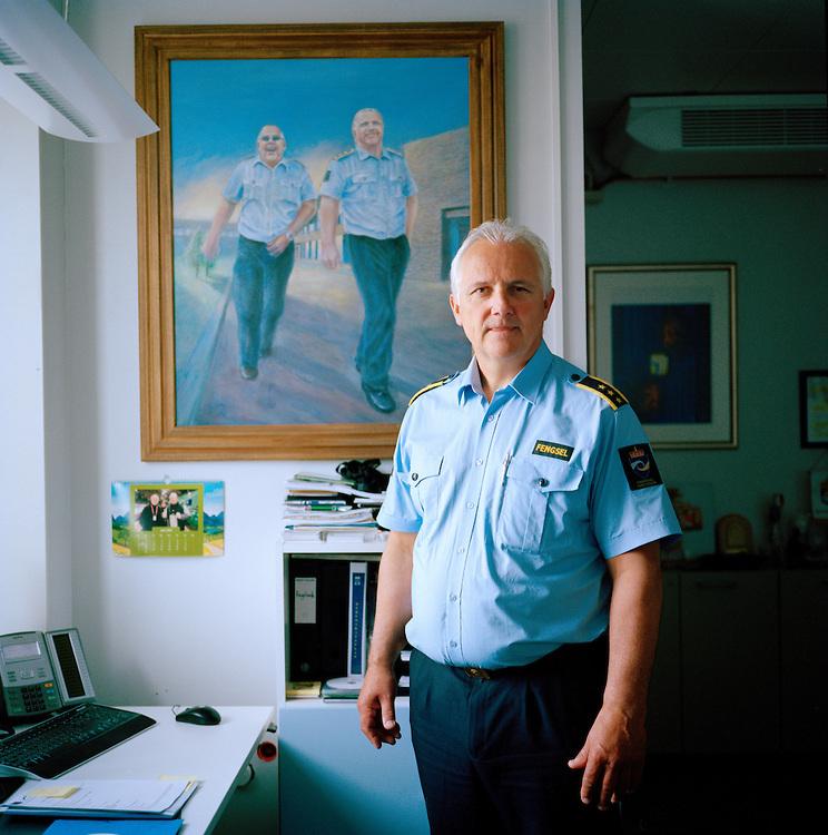 Halden Prison, Norway, June 2014: The Governor of Halden Prison, Are Høidal, in his office. The painting is made by a prisoner and shows Are and his closest coworker Jan Strømnes. -- No commercial use -- Photo: Knut Egil Wang/Moment/INSTITUTE