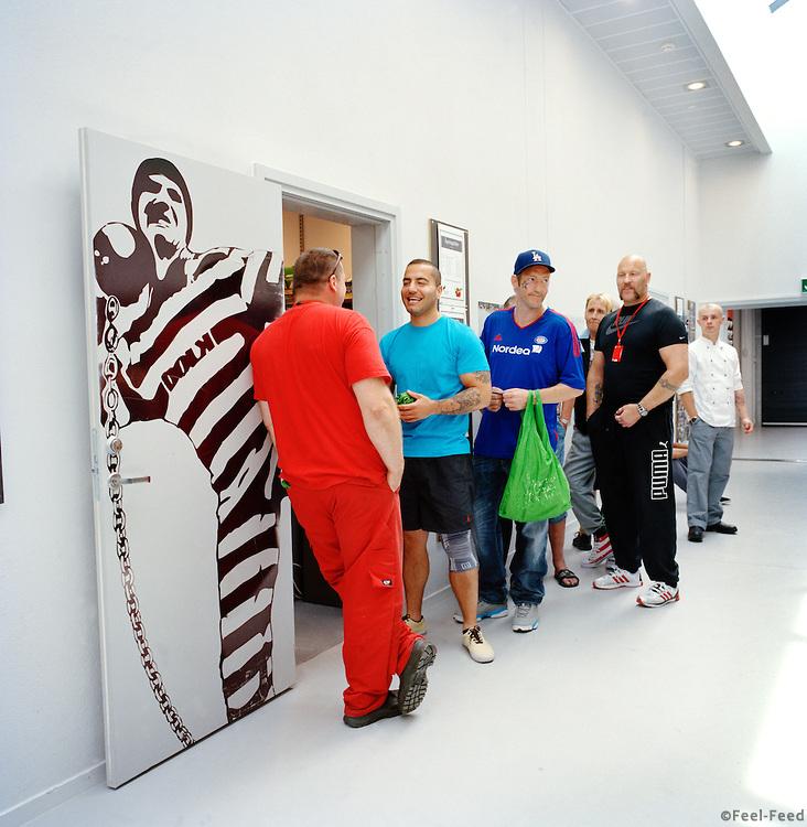 Halden Prison, Norway, June 2014: Inmates in line to shop for food in the prison grocery store. -- No commercial use -- Photo: Knut Egil Wang/Moment/INSTITUTE