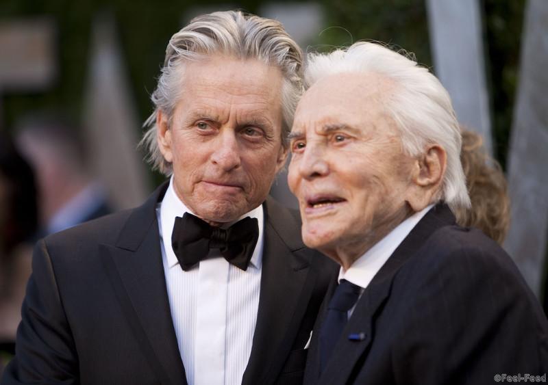 Michael Douglas (L) greets his father Kirk Douglas on the carpet as they arrive at the Vanity Fair Oscar Party, for the 84th Annual Academy Awards, at the Sunset Tower on February 26, 2012 in West Hollywood, California. AFP PHOTO / ADRIAN SANCHEZ-GONZALEZ (Photo credit should read ADRIAN SANCHEZ-GONZALEZ/AFP/Getty Images)