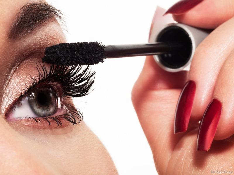Woman eye with long eyelashes and mascara brush