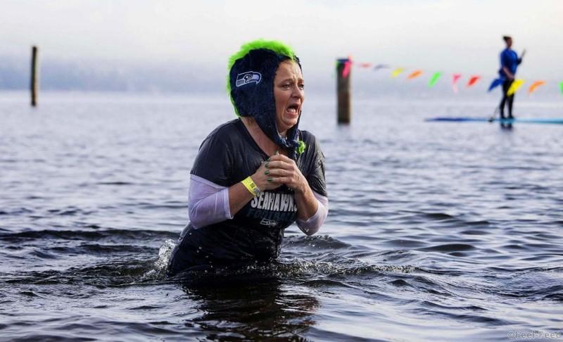 A woman reacts after entering Lake Washington during the 12th annual Polar Bear Plunge in Seattle, Washington. Hundreds participated in the chilly New Year's Day tradition, organized by Seattle Parks and Recreation and held at Matthews Beach. (David Ryder/Reuters)