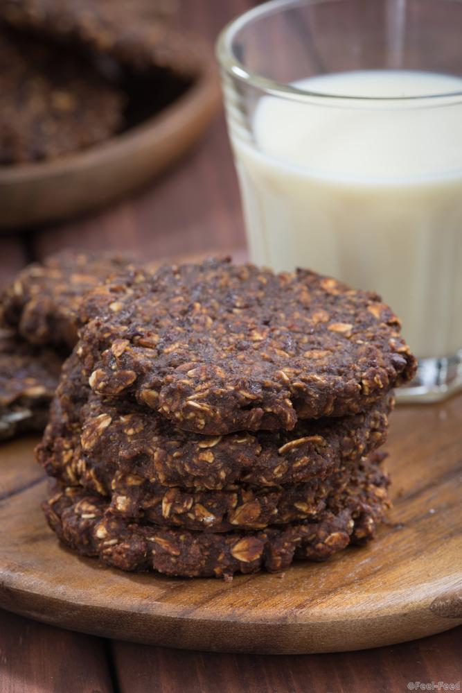 chocolate oatmeal cookies and a glass of milk, closeup, vertical