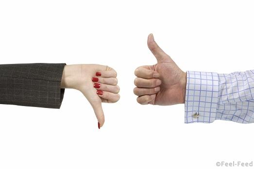 Male and female executives disagreeing over a deal or decision (red nail polish makes woman's hand stand out).