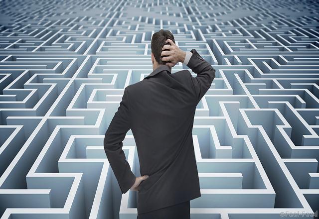 Back of businessman getting lost in a maze