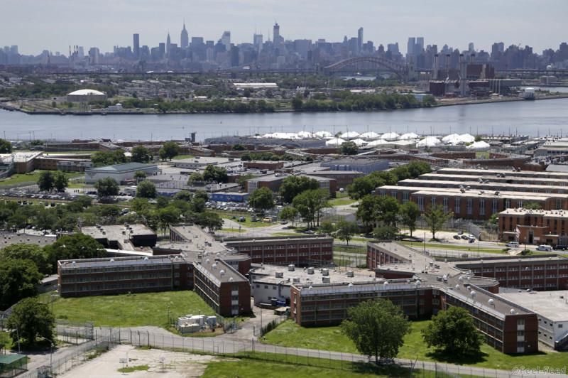 This June 20, 2014, aerial photo shows Riker's Island jail, in New York. Investigative documents obtained by The Associated Press on the 11 suicides in New York City jails over the past five years show that in at least nine cases, protocols and safeguards designed to prevent inmates from harming themselves were not followed. (AP Photo/Seth Wenig)