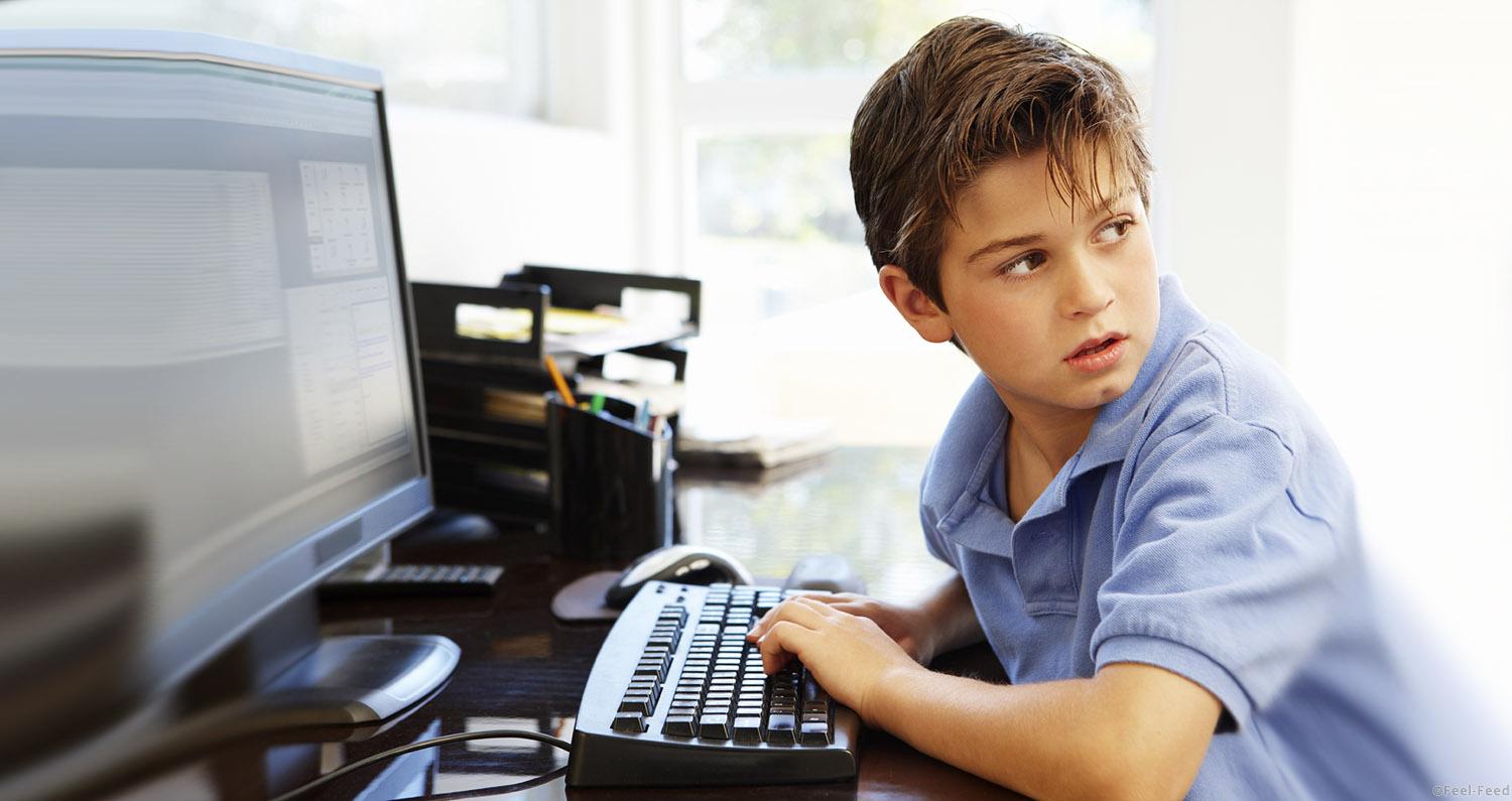 Young boy using computer at home
