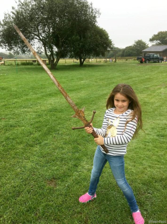 Matilda Jones, from Norton, Doncaster, with the sword.  A schoolgirl could become a thing of legend after pulling an historic sword from the same Cornish lake where King Arthur's Excalibur was famously thrown.  See ROSS PARRY story RPYSWORD.  Little Matilda Jones. Aged seven, came home with the perfect holiday souvenir after stumbling across the sword which is the same height as her.  She found the 4ft long metal blade while paddling in waist deep waters at Dozmary Pool on August 29.  Proud dad Paul Jones, 51, had only told Matilda and her sister Lois, four, about the legend of King Arthur moments before the discovery during a six-day holiday in Cornwall.  The 51-year-old, from Doncaster, south Yorks., predicts that the sword is probably around 30 years old and was used as an old film prop.
