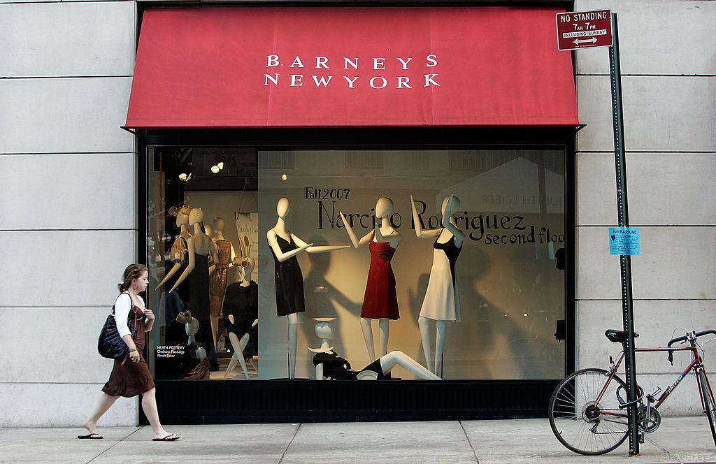NEW YORK - JUNE 22:  A woman walks past a Barneys New York store window June 22, 2007 in New York City. Jones Apparel Group Inc. plans to sell Barneys New York to the Dubai investment firm Istithmar for $825 million.  (Photo by Mario Tama/Getty Images)