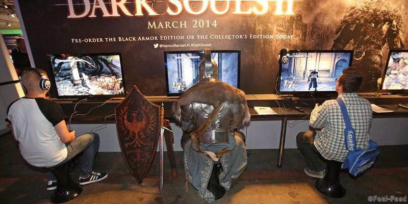 A person dressed as a character from the Dark Souls II game (centre), plays the game during the Eurogamer Expo at Earls Court in London.