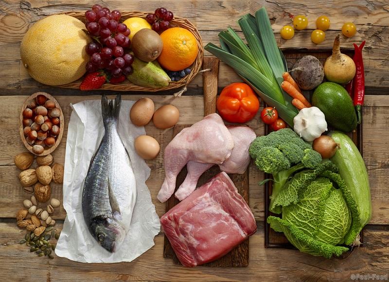 Various Paleo diet products on wooden table, top view