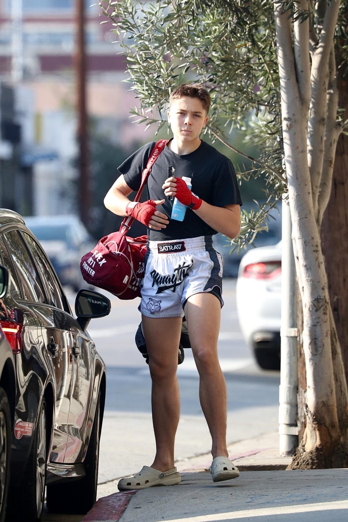 *EXCLUSIVE* Los Angeles, CA   *WEB MUST CALL FOR PRICING*  The champion is here! Knox Léon Jolie-Pitt was seen flexing fresh off a weekend Muay Thai victory in Los Angeles. Dressed in fighter shorts, red wraps, and Crocs, the 16-year-old looked focused and fierce as he headed to training, still buzzing from his recent tournament triumph. Pictured: Knox Jolie-Pitt BACKGRID USA 14 JULY 2025  USA: +1 310 798 9111 / usasales@backgrid.com UK: +44 208 344 2007 / uksales@backgrid.com *UK Clients - Pictures Containing Children Please Pixelate Face Prior To Publication*